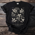 Black t-shirt with botanical illustrations of hedgerow plants and text "The Hedgerow Harvest".