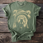 Green t-shirt with a beige distressed print of a koala wearing a beanie.