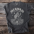 Dark grey t-shirt with white graphic of a mermaid holding a mirror, "MERMAID ocean sea siren folklore" text.