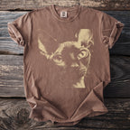 Brown Comfort Colors t-shirt with a cream graphic of a Sphynx cat's face.