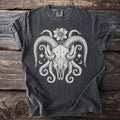 Dark gray t-shirt with a white graphic of a ram skull with tentacles and stars.