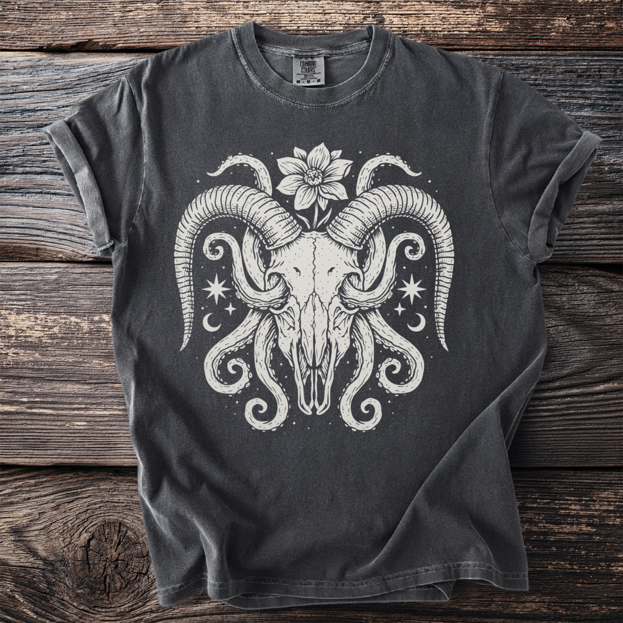 Dark gray t-shirt with a white graphic of a ram skull with tentacles and stars.