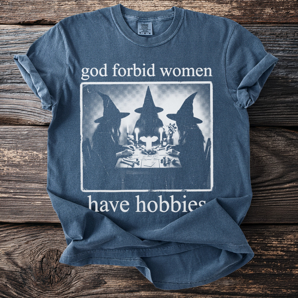 Blue t-shirt with "god forbid women have hobbies" and witch graphic.