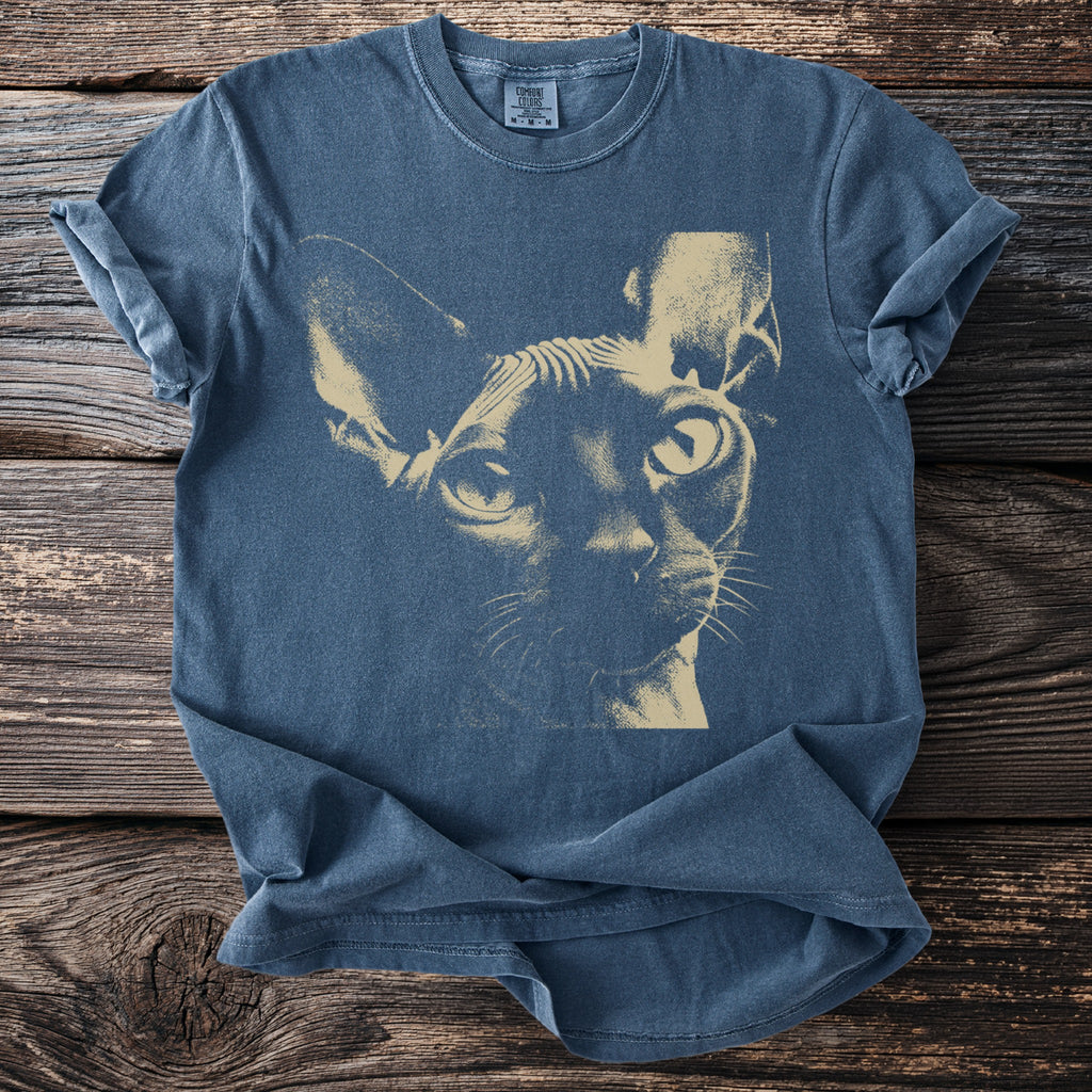 Blue t-shirt with a tan sphinx cat portrait graphic.