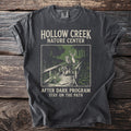 T-shirt with Hollow Creek Nature Center design featuring animals on a bridge.
