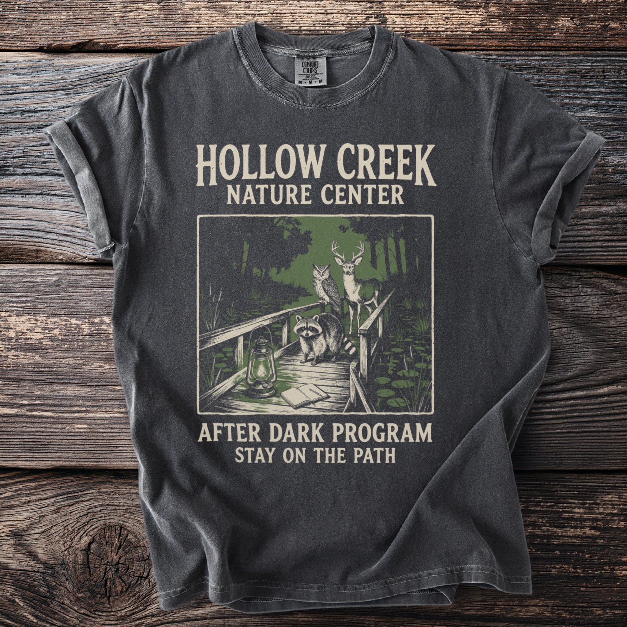 T-shirt with Hollow Creek Nature Center design featuring animals on a bridge.