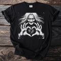 Black t-shirt with a sketch of a witch making a heart shape with her hands.