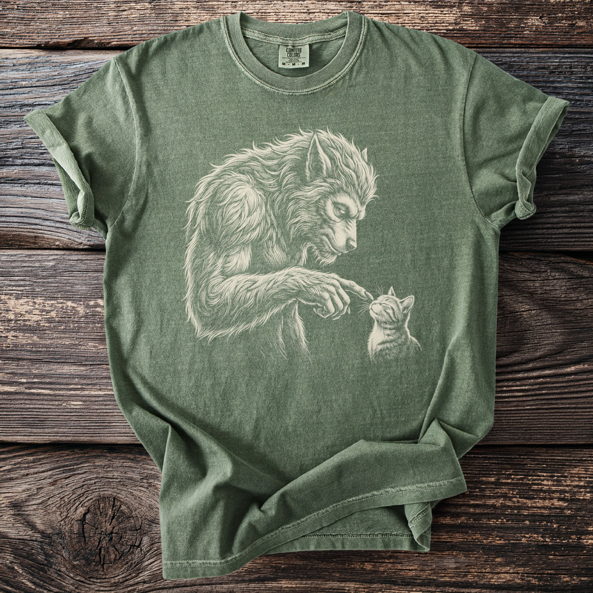 Green t-shirt with a sketch of a werewolf gently touching a kitten.
