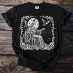 Black t-shirt with a white graphic of a woman spinning constellations by a full moon.