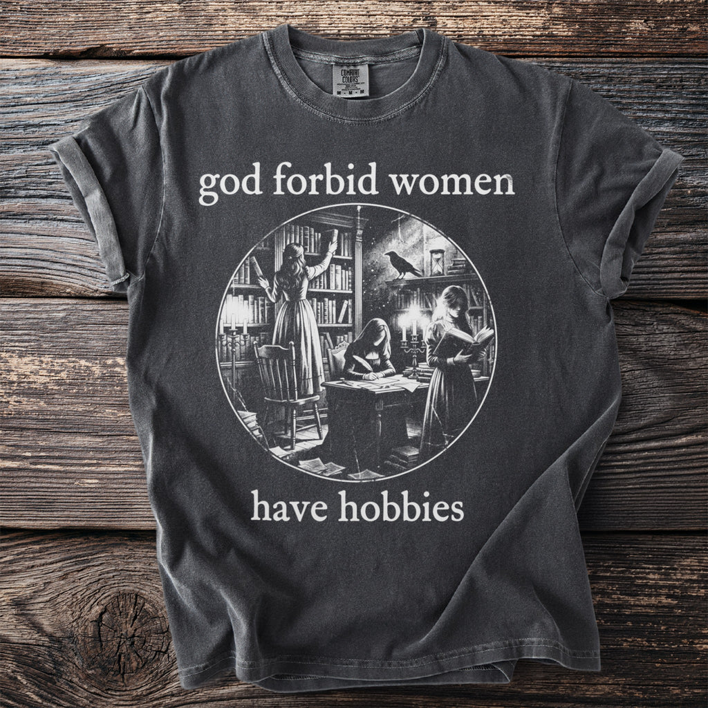 T-shirt with "god forbid women have hobbies" text and a circular graphic of women reading and writing.
