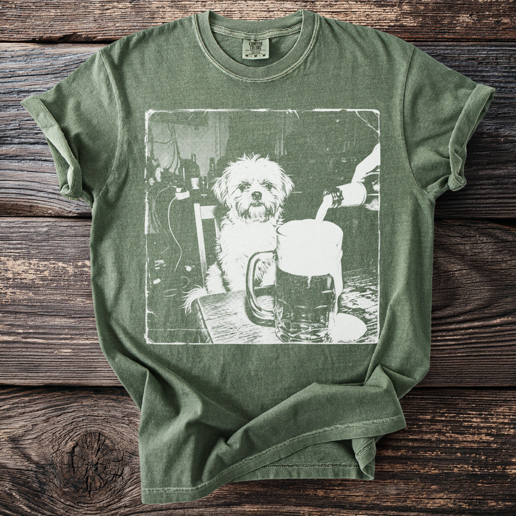 Green t-shirt with graphic of dog sitting at a table with a beer being poured.