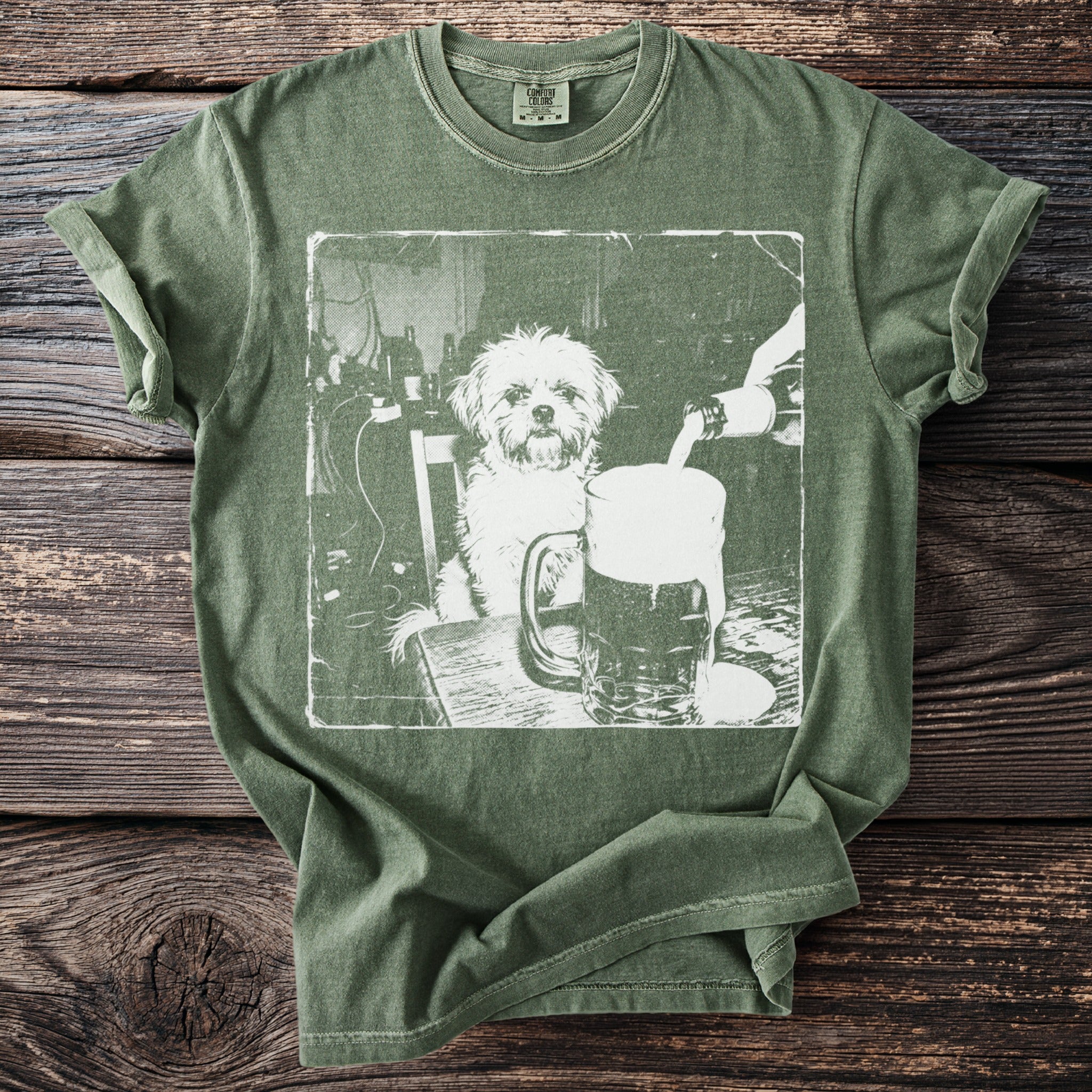 Green t-shirt with graphic of dog sitting at a table with a beer being poured.