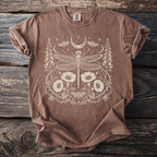 Brown t-shirt with a cream dragonfly, moon, moth, and floral design.