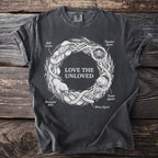 Dark t-shirt with "Love the Unloved" text and wreath of creatures.