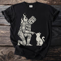 Black t-shirt with a beige print of a wicker man figure kneeling and touching a cat.