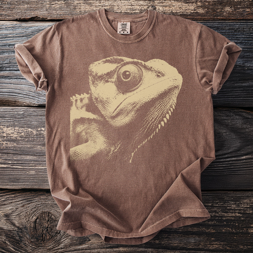 Brown t-shirt with a beige graphic of a lizard's head.