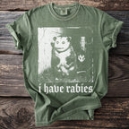 Green t-shirt with image of possum and text "i have rabies".
