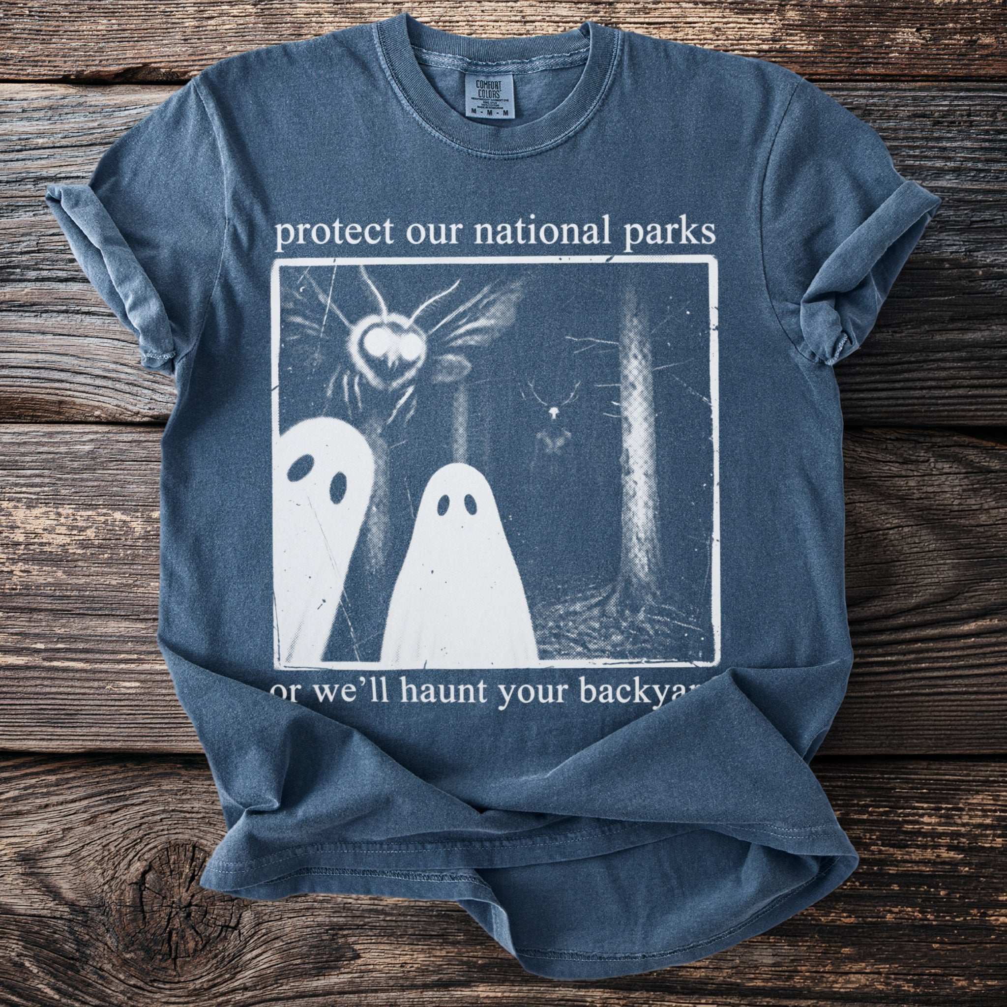 T-shirt with white text and graphic: protect our national parks or we'll haunt your backyard.