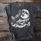 T-shirt with a black and white graphic of two ravens, a full moon, and a mountain landscape.