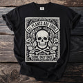 Black t-shirt with skull, bones, floral design, and text "ALL PLANTS ARE EDIBLE SOME ONLY ONCE".
