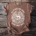Brown t-shirt with a white circular graphic of a skull surrounded by plants and the text "ALL PLANTS ARE EDIBLE SOME ONLY ONCE".