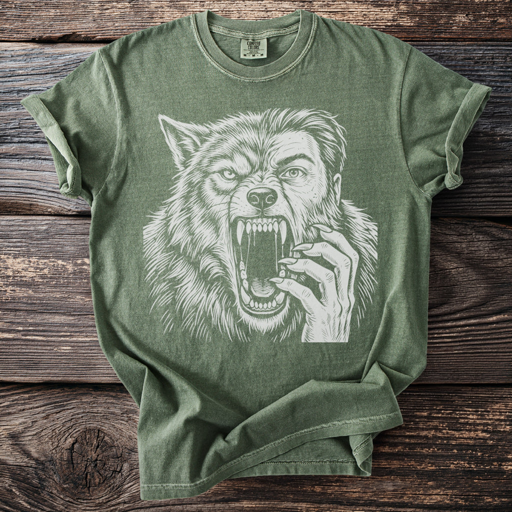 Green t-shirt with a white graphic of a werewolf's face and hand.