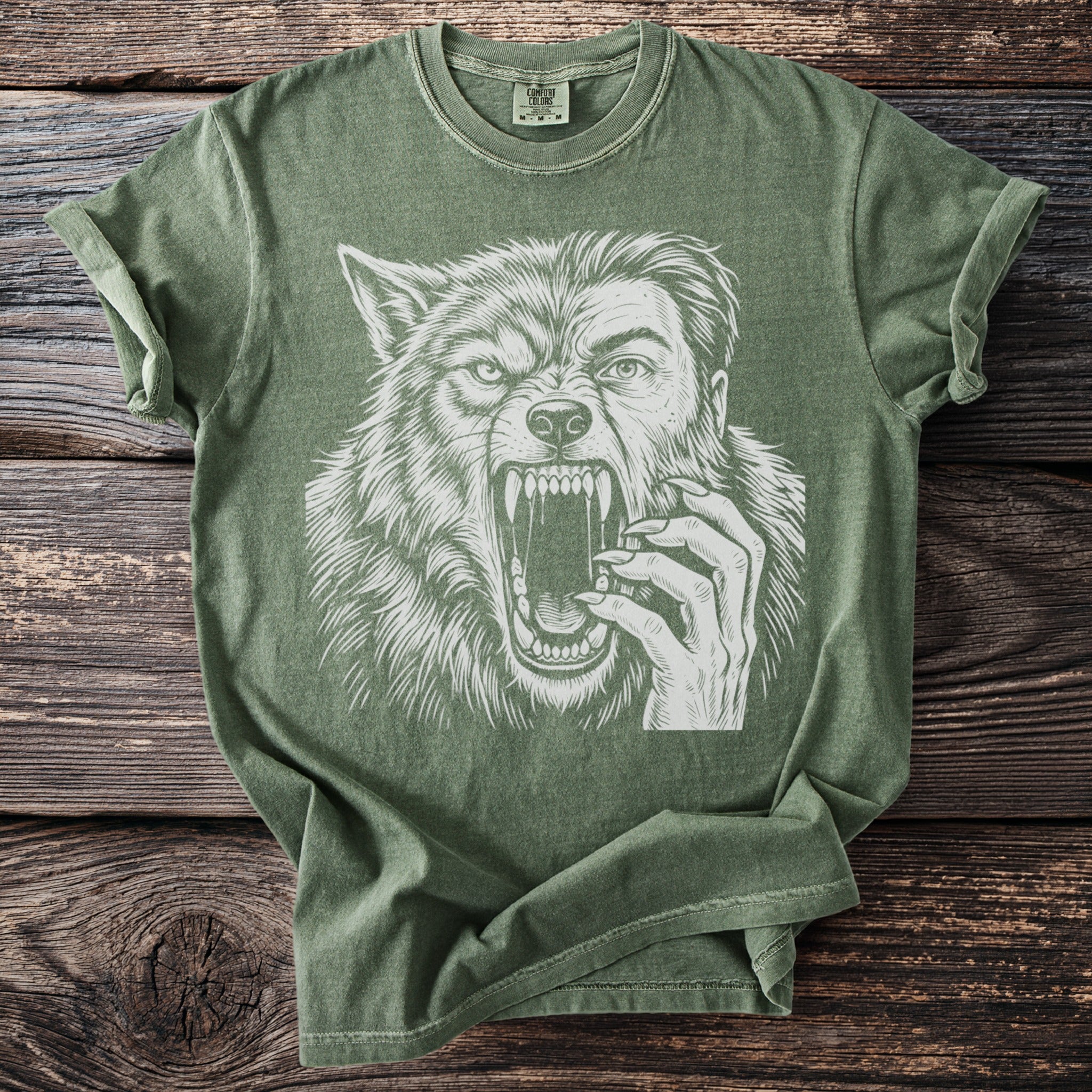 Green t-shirt with a white graphic of a werewolf's face and hand.