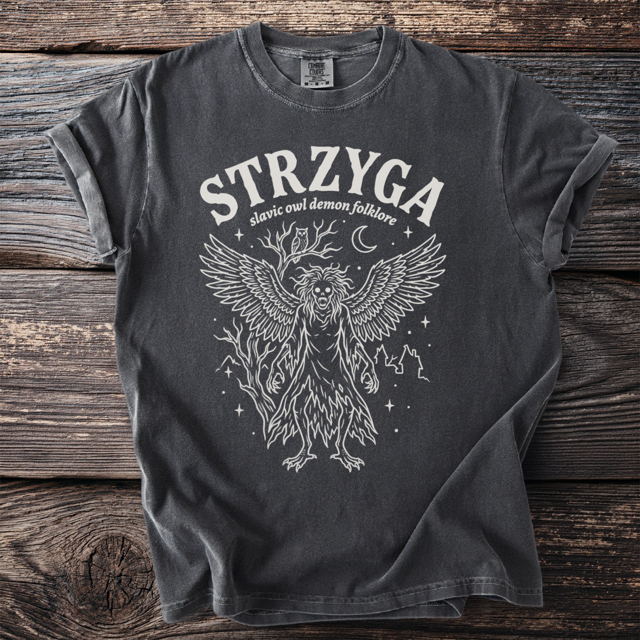 T-shirt with white linework of a winged demon, owl, moon, and trees.