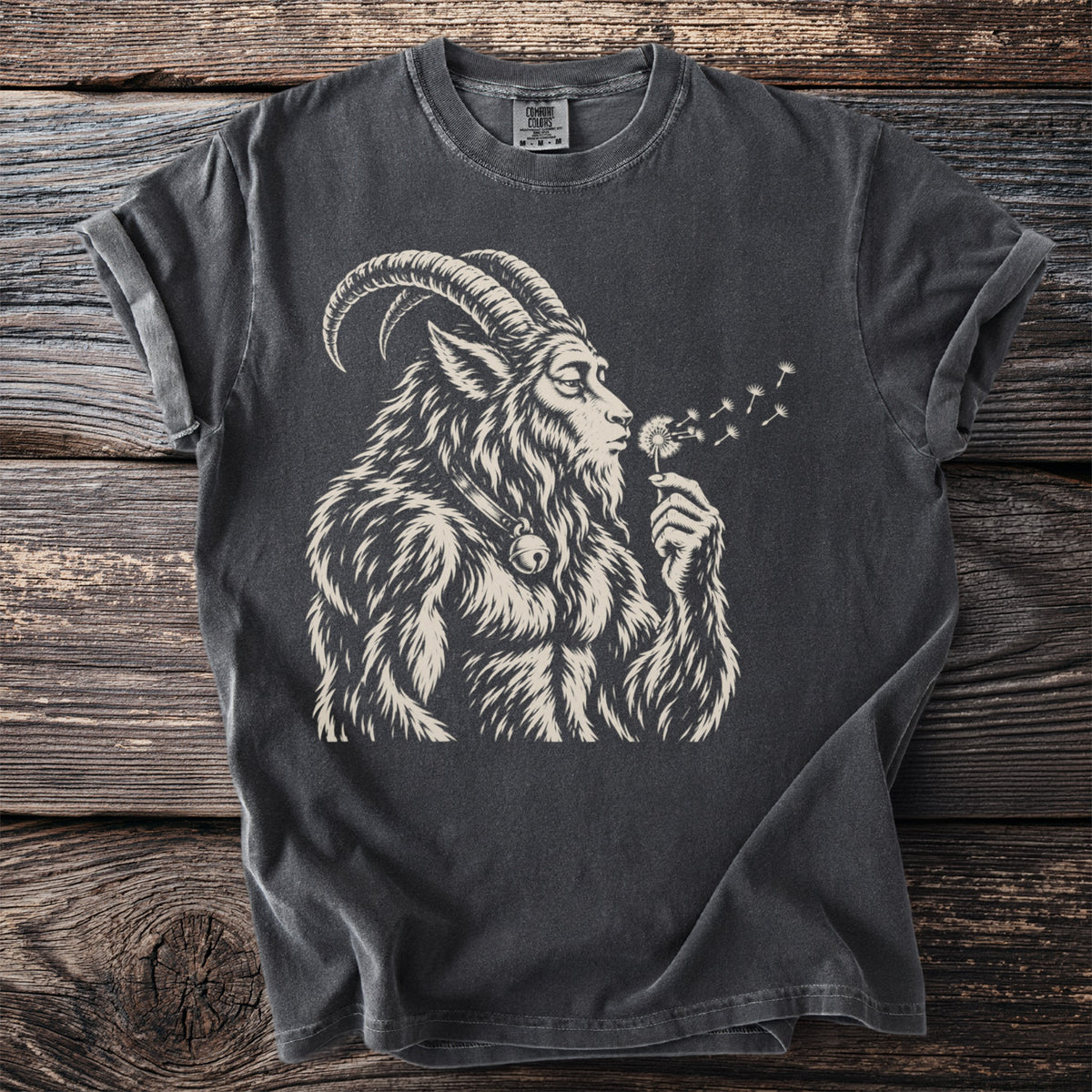 T-shirt with a stylized goat-human creature blowing on dandelions.