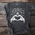 T-shirt with Medusa graphic making a heart shape with hands.