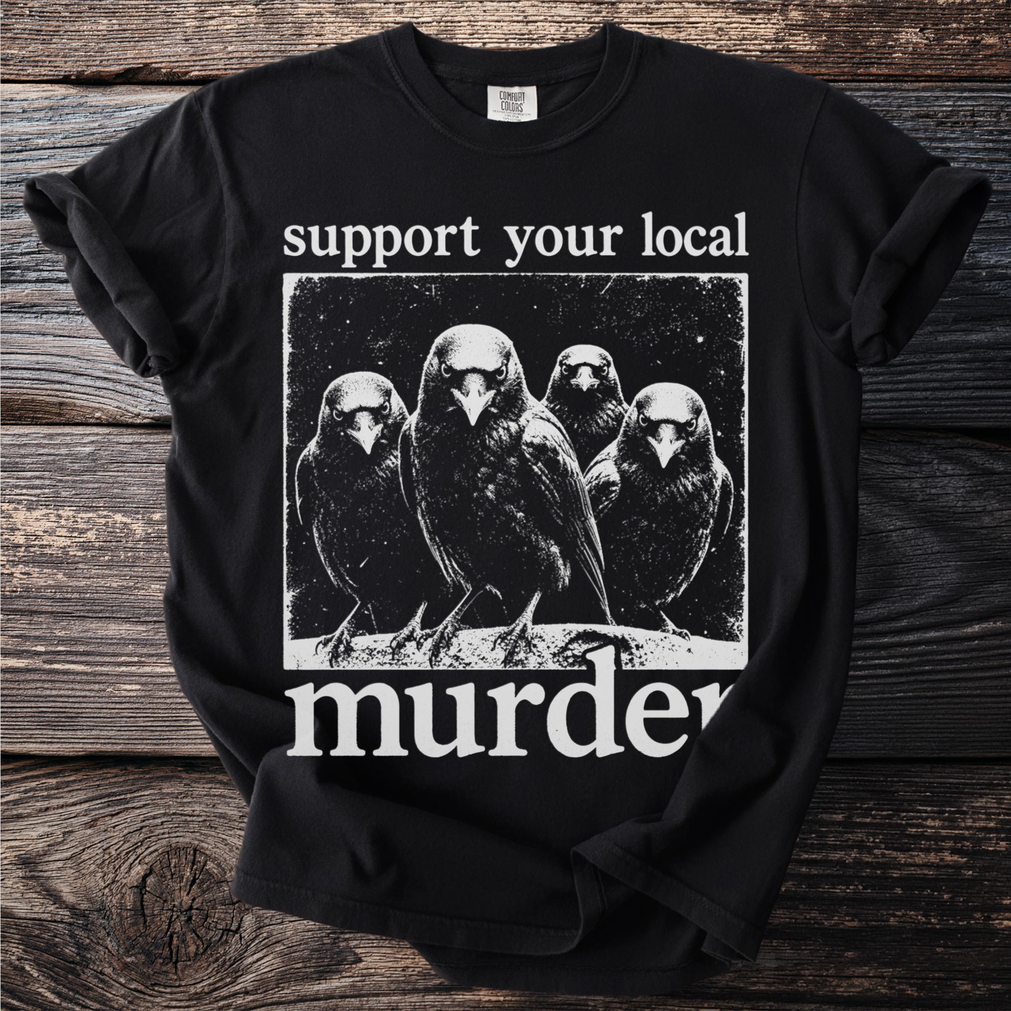Black t-shirt with white text and image of four crows saying "support your local murder".