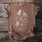 Brown t-shirt with a vintage illustration of various corvid birds and text.
