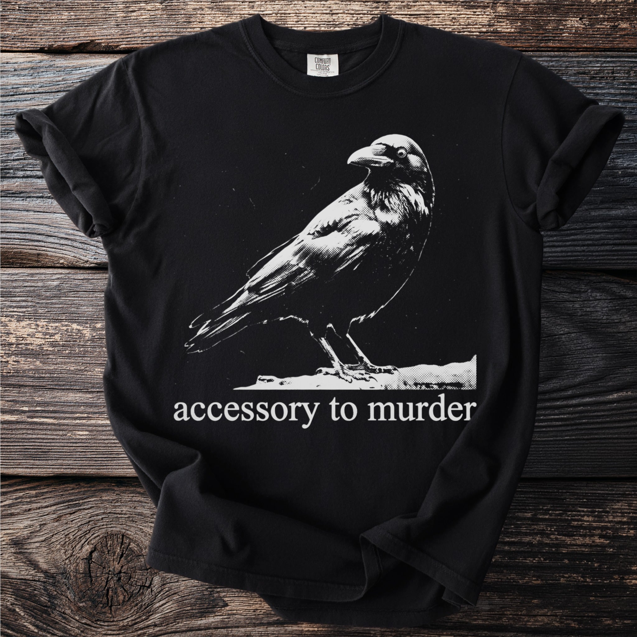 Black t-shirt with a crow graphic and text "accessory to murder"