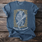 Blue t-shirt with vintage Krampus illustration and "Naughty List Approved" text.
