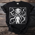 Black t-shirt with white graphic of astronaut facing a kraken with tentacles.