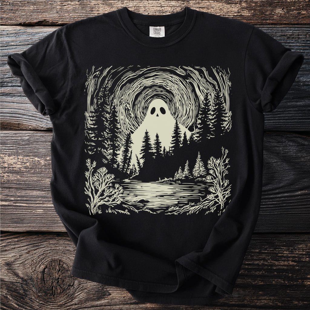 Black t-shirt with a cream linocut design of a ghost in a dark forest.