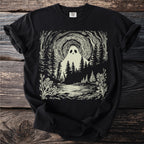 Black t-shirt with a cream linocut design of a ghost in a dark forest.