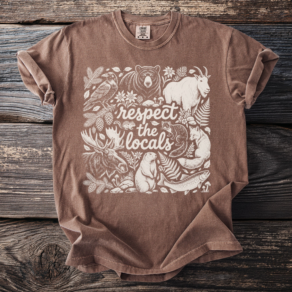 Brown t-shirt graphic with woodland animals and text "respect the locals."