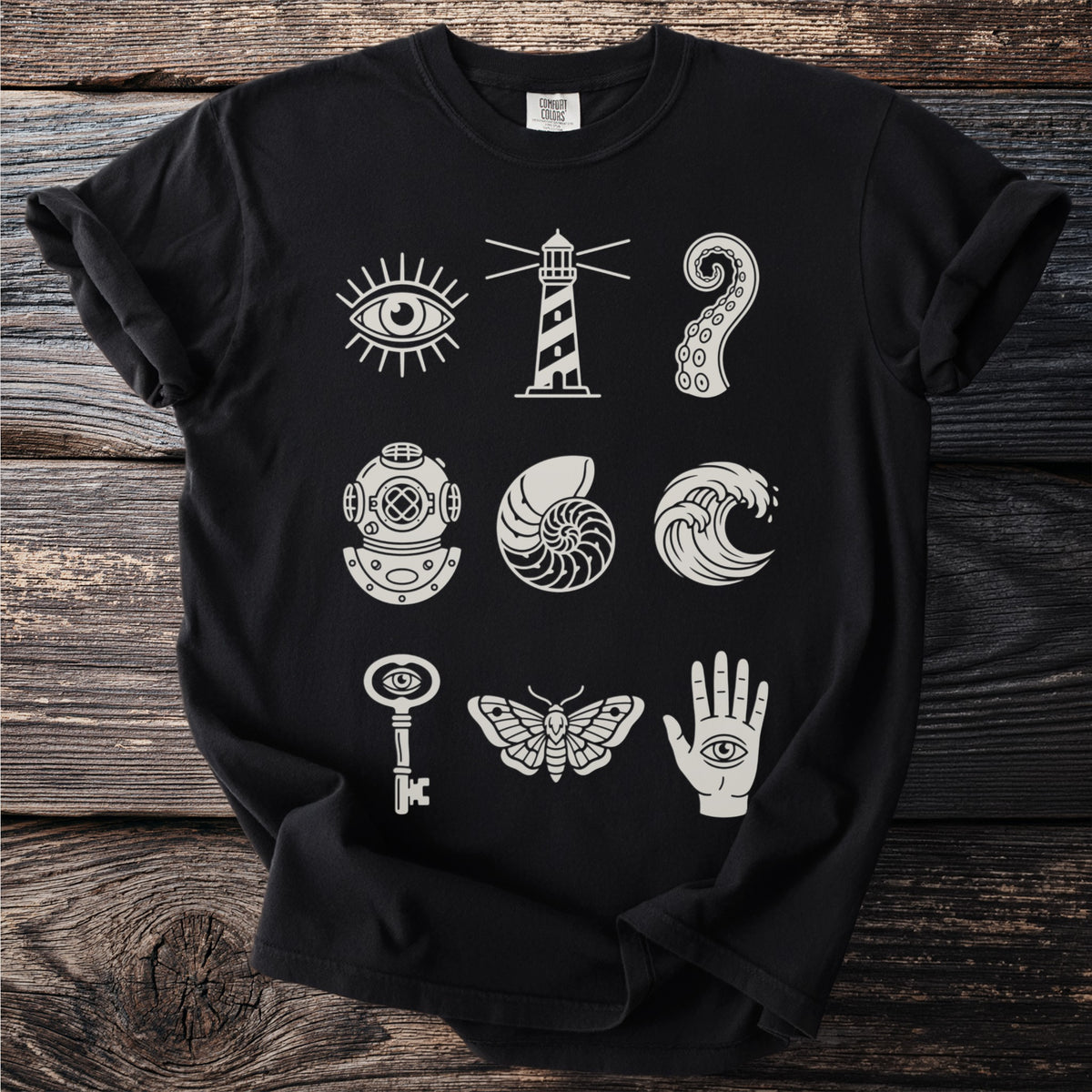 Black t-shirt with nine light-colored mystical and nautical icons.