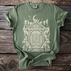 Green t-shirt with Viking-inspired distressed graphic of a gate, wolves, and raven.