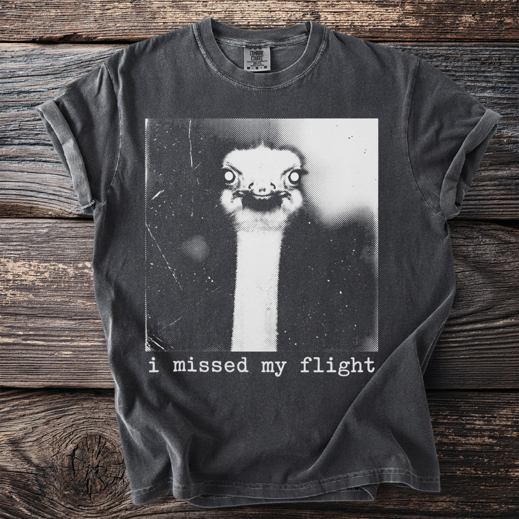 T-shirt with black and white graphic of an ostrich head and the text "i missed my flight".