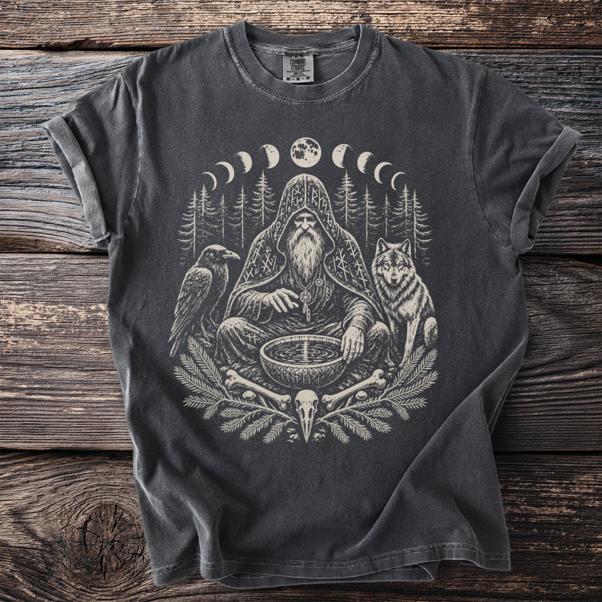T-shirt with a raven, wolf, and bearded figure with moon phases and runes.