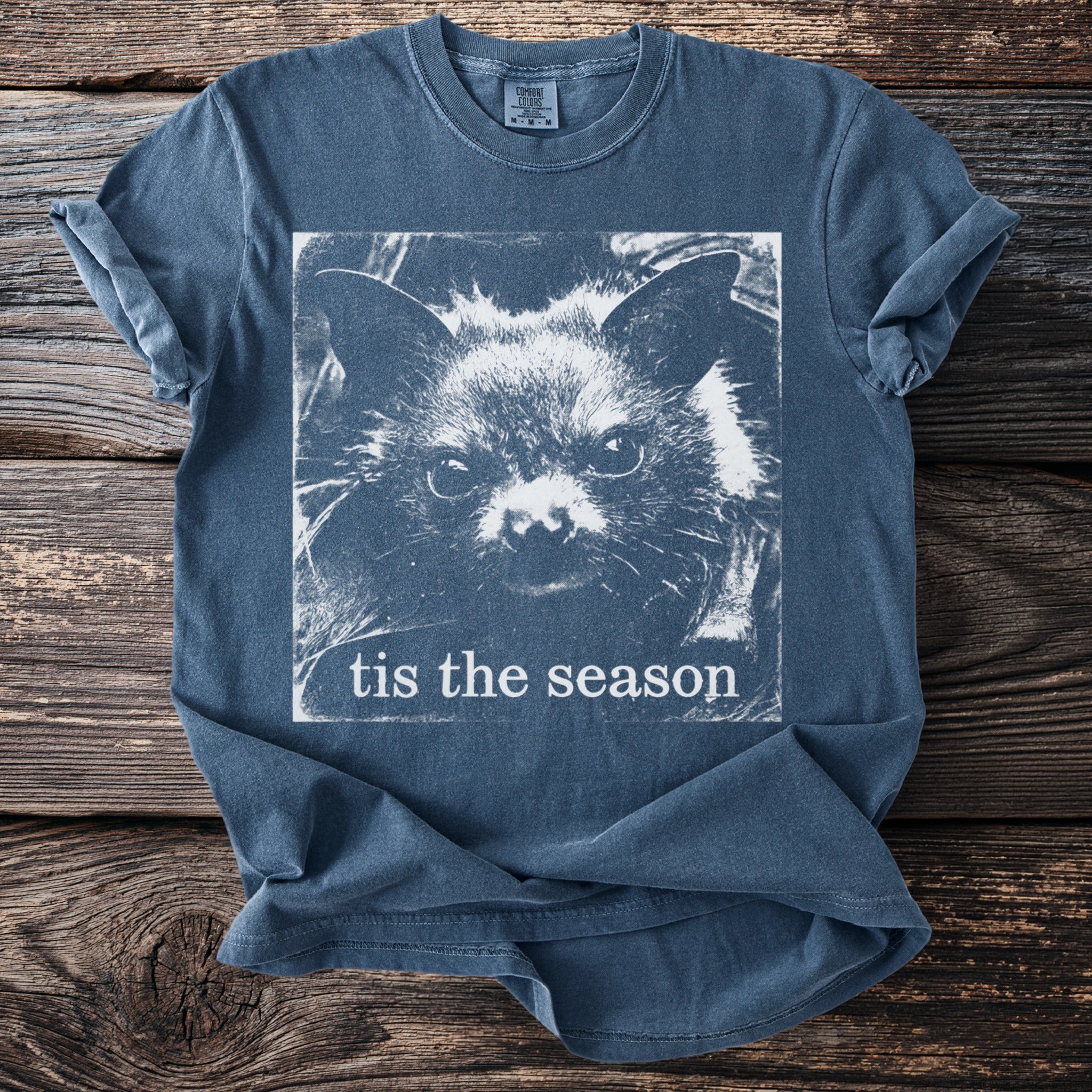 Blue t-shirt with a white bat face graphic and text "tis the season".