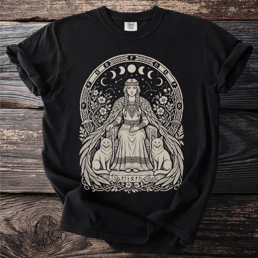 Black t-shirt with a beige Norse goddess sitting with two cats and celestial moon phases.