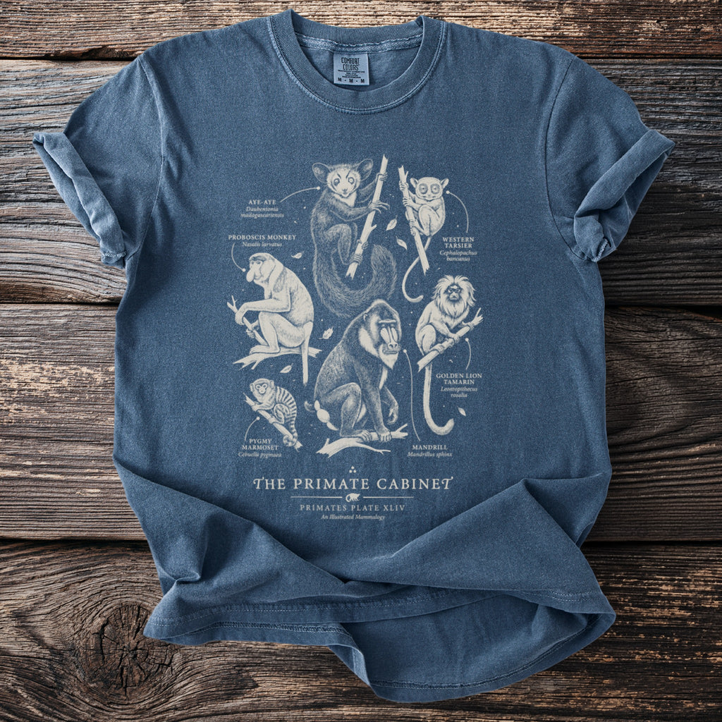 Blue t-shirt featuring a detailed illustration of the primate cabinet with species names.