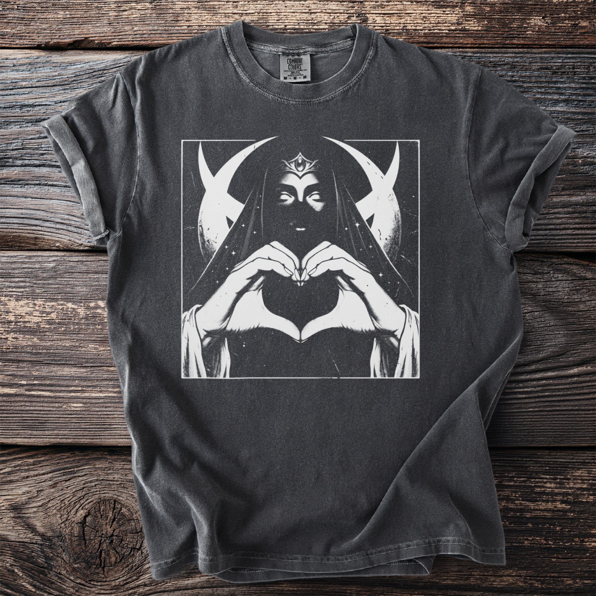 T-shirt with graphic of a veiled figure making a heart with hands under moons.