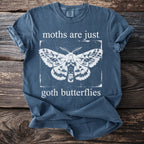 Blue t-shirt with white moth graphic and text "moths are just goth butterflies".