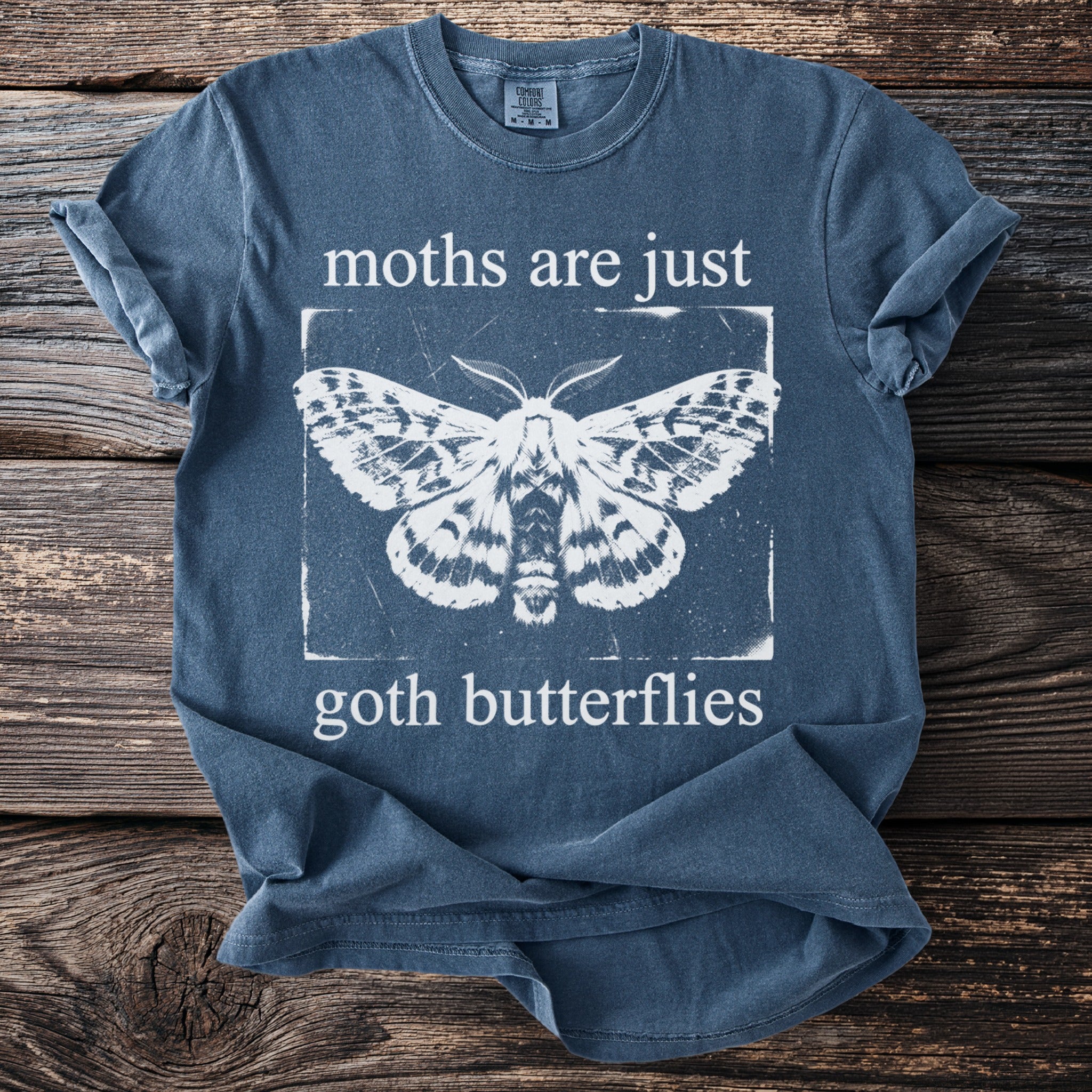 Blue t-shirt with white moth graphic and text "moths are just goth butterflies".
