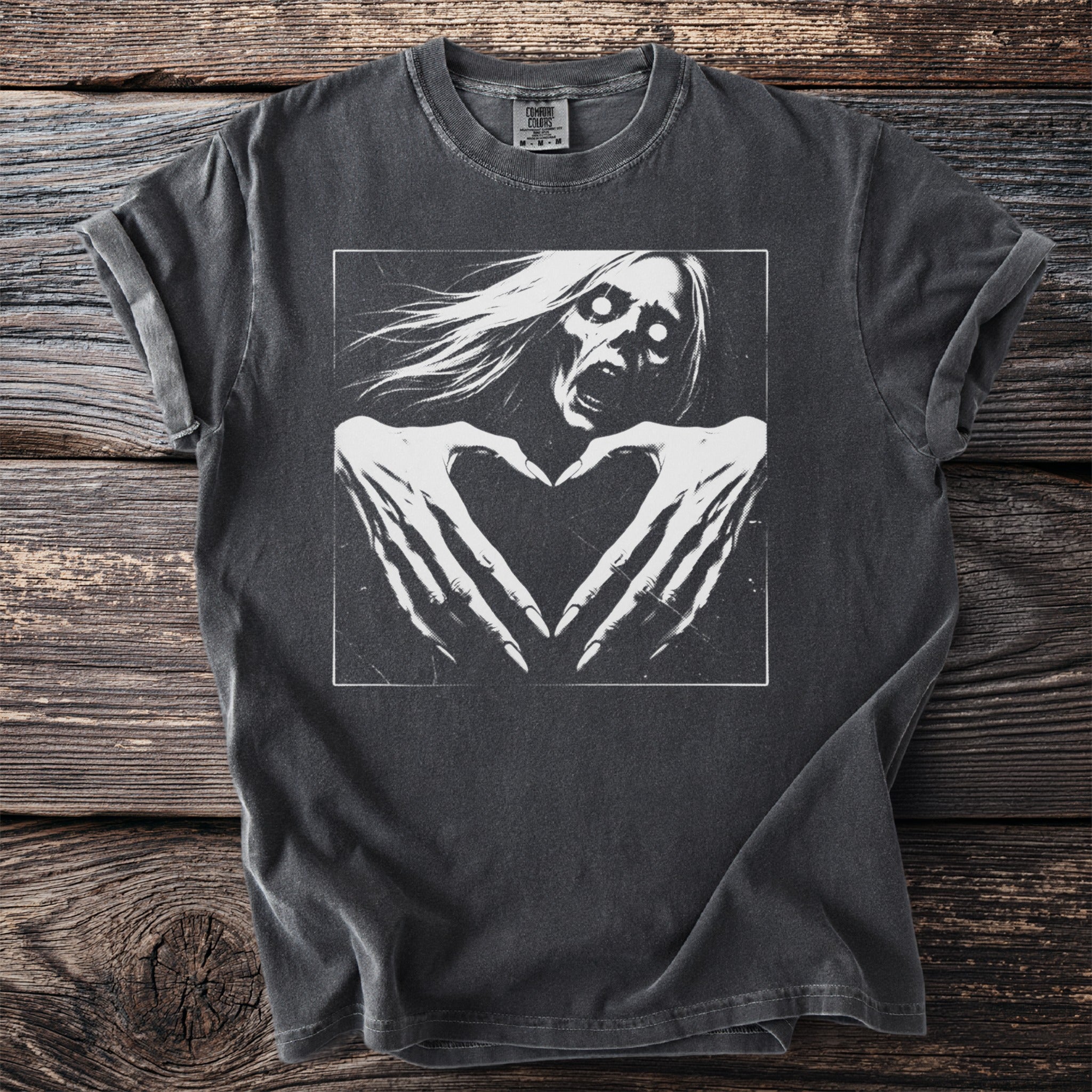 Charcoal t-shirt with graphic of a screaming ghost forming a heart with its hands.