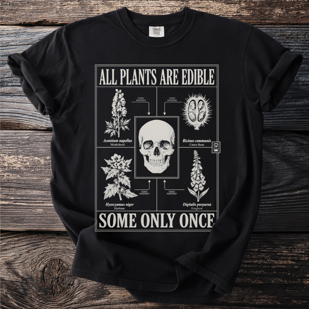 Black t-shirt with "ALL PLANTS ARE EDIBLE SOME ONLY ONCE" and toxic plant illustrations.